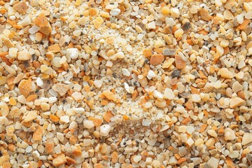  Extreme macro shot of sand grains with visible texture, warm beige and light brown hues.