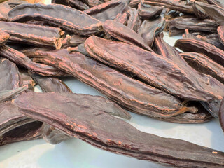 Dried carob pods close-up display