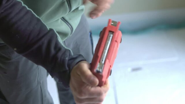Worker loads staples into a staple gun