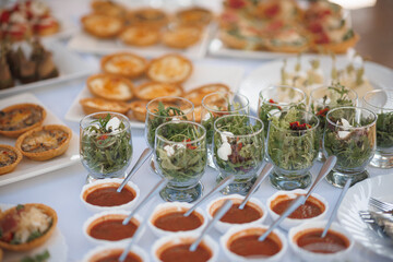 On the dining table, you can find a variety of different types of food arranged beautifully for everyone to enjoy and taste