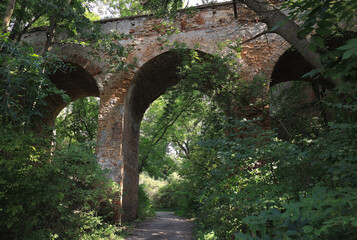 Naklejka premium Photo from below with a view of the high Klevan viaduct among green spaces in the town of Klevan, Rivne region of Ukraine