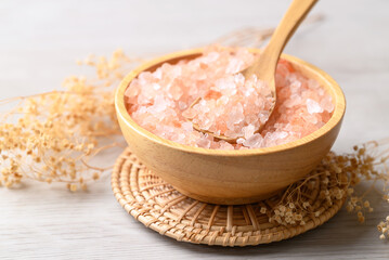Organic Himalayan pink salt in wooden bowl with spoon, Healthy food ingredient