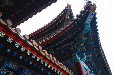 While observing the architectural features of a traditional Chinese building, I find myself captivated by the intricate design of its roof