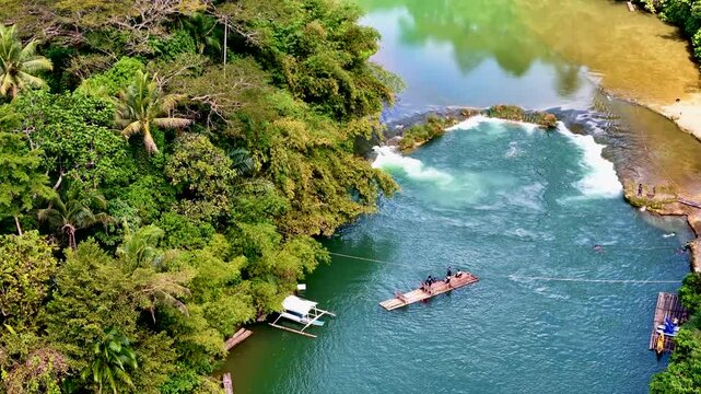 Loboc River with small waterfall and river threshold in Bohol island, Philippines. Aerial 4K drone video footage of river popular for river cruises 