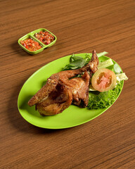 Crispy Fried Free-Range Chicken Served with Fresh Vegetables and Spicy Sambal.