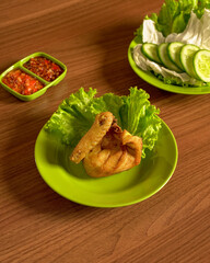 Golden Fried Free-Range Chicken with Fresh Lettuce, and Traditional Indonesian Sambal.
