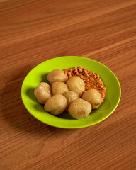 Spicy Cilok Bumbu Goang Chewy Tapioca Balls with Fiery Chili Sauce for a Tasty Street Food Snack.