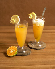Refreshing Iced Orange and Iced Orange Coconut Drinks with Citrus Garnish, Perfect for a Tropical and Sweet Summer Treat.