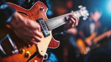 Obraz premium Close-up of guitarist performing live on stage with band in background