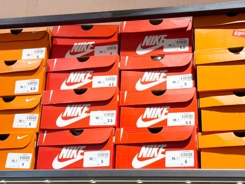 Stacked nike shoe boxes display with pricing labels in retail store