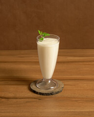A Glass of Refreshing and Creamy Juice Made from Tropical Soursop Fruit, Served Cold for a...