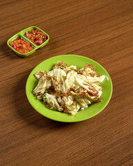 A Flavorful Indonesian Side Dish Featuring Deep-Fried Cabbage Served with Spicy and Savory Chili Sambal.