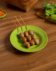 Grilled Quail Egg Satay Served with Fresh Vegetables and Spicy Sambal, Indonesian Street Food with Bold and Savory Flavors.
