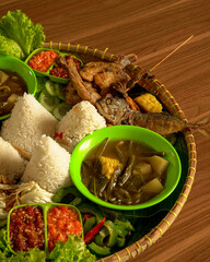 Classic Indonesian Sundanese Platter with Fried Chicken, Salted Fish, Lalapan, Soup, Complete Sides and Spicy Sambal.