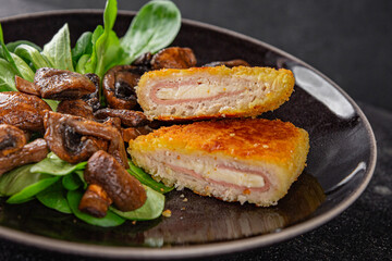 Cordon Bleu Cutlet meat chicken, ham, cheese appetizer dish fresh delicious gourmet food background on the table rustic food top view copy space