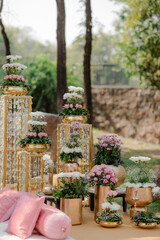 Exquisite floral arrangements in gold containers create a stunning and elegant ambiance, perfect for celebrations and adding a touch of sophistication.