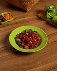 Stir-Fried Tempeh with Assorted Fresh Vegetables and Spicy Sambal on the Side, a Flavorful and Healthy Traditional Indonesian Plant-Based Dish.