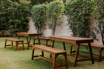 Outdoor Gathering: Wooden tables and benches set up on a lawn in a garden setting. Ideal for...