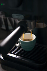 Small cup of espresso in a home coffee machine