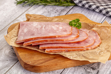 Sliced porjk ham over boatd
