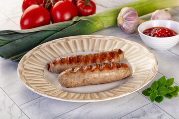 Grilled pork sausages served tomato sauce