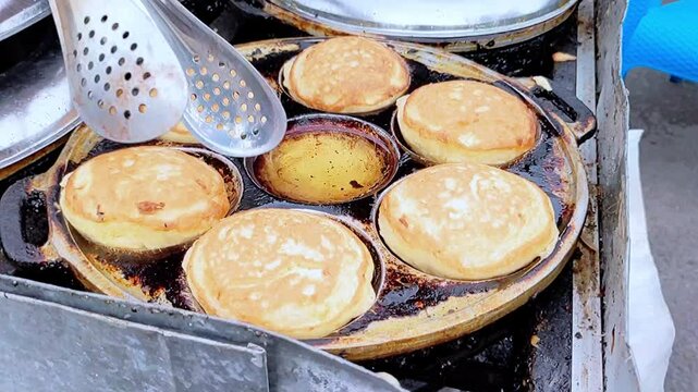 An interesting footage of the traditional baking process of Samir or Kamir or Khamir pancake on cast iron muffins pan. the cake is made of flour, butter, and egg dough