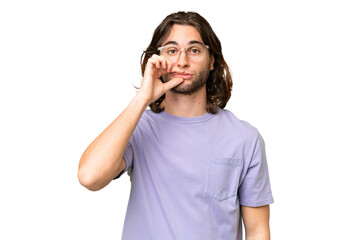 Young handsome man over isolated background showing a sign of silence gesture
