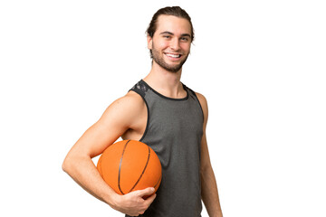Obraz premium Young handsome man isolated on green chroma background playing basketball