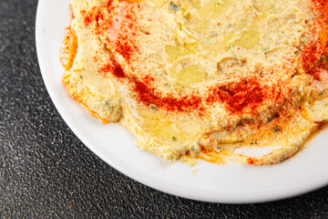 Hummus chickpea dip tasty appetizer vegetable dish fresh gourmet vegetarian and vegan food background on the table rustic food top view copy space