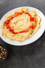 Hummus chickpea dip tasty appetizer vegetable dish fresh gourmet vegetarian and vegan food background on the table rustic food top view copy space