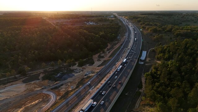 aerial of Florida Turnpike FL-91 at sunset, with traffic congestion as far as the eye can see near Clermont, Florida