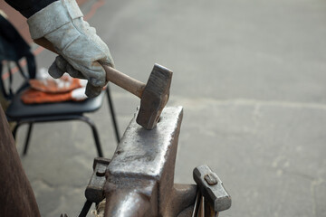 Blacksmith hits anvil. Hammer and anvil. Metal Processing Details.
