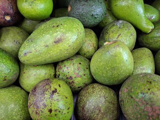 Pile of Green Avocados: Textured Skins, Fresh Produce.
