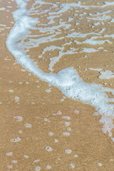 Tranquil Sandy Beach with Foamy Waves