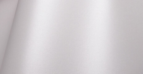 Satin paper background with a pearlescent, glossy texture and smooth surface. Pale silver and icy grey tones create a clean, elegant, and luxurious abstract design with subtle shimmer and a sleek,.