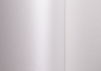 White satin paper background with a glossy, smooth texture and folded vertical waves. Pale grey and icy silver tones create a bright, elegant, and luxurious abstract design with subtle shimmer, clean.