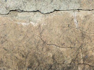Obraz premium Cracked plaster wall texture, aged surface, grunge background, damaged stucco, weathered material