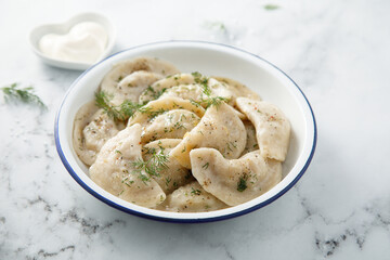 Traditional dumplings served with dill and sour cream