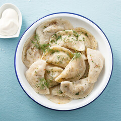 Traditional dumplings served with dill and sour cream