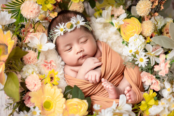 A sleeping newborn baby surrounded by beautiful flowers peacefully rests.