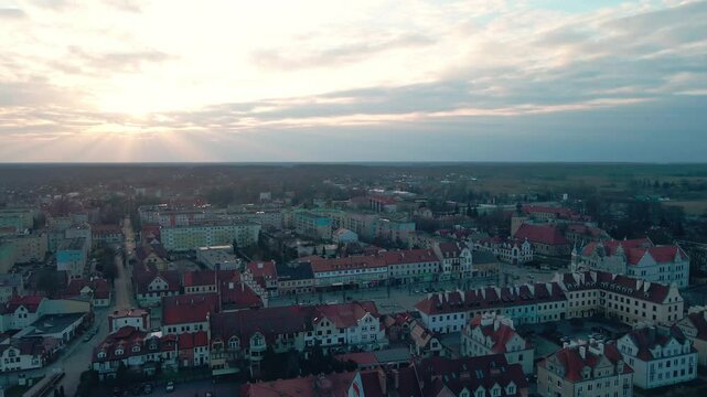 Wide aerial view of Pisz Poland at sunset showing Pisza River, historic town and rural surroundings