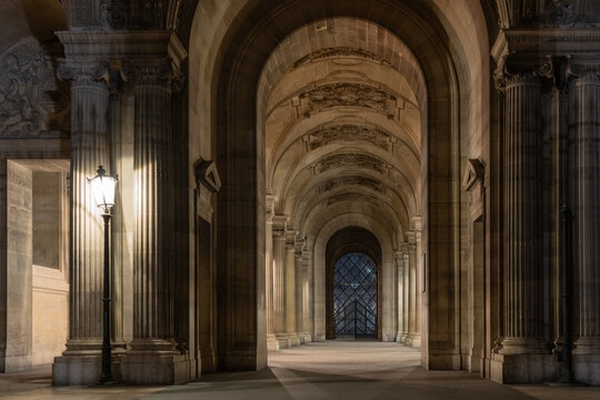 View of entrance way of Louvre (Paris, France) seen from Quai Fran&ccedil;ois Mitterand at night.