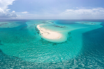 Tourists enjoy the tropical sandbar of Nakupenda Beach, Zanzibar, Tanzania..