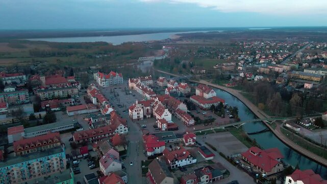 Aerial view of Pisz Poland at dusk with town hall, Pisza River, bridges and lake in background