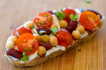 Close up details of bruschetta with tomatoes, basil and nuts