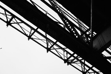Black and white photograph depicting industrial bridge structure