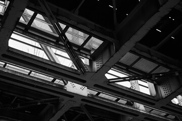 Black and white photograph depicting industrial bridge structure