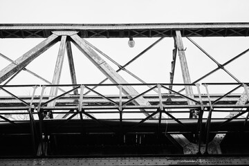 Black and white photograph depicting industrial bridge structure