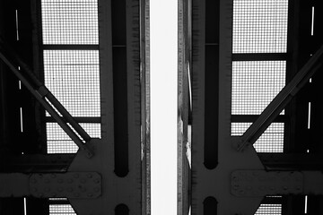 Black and white photograph depicting industrial bridge structure
