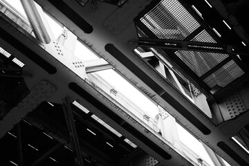 Black and white photograph depicting industrial bridge structure